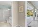 Bathroom featuring a shower and vanity with a view to the pool area at 2632 Turnbull Estates Dr, New Smyrna Beach, FL 32168