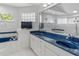 Bright bathroom with double sinks and a soaking tub with blue tile accents at 2632 Turnbull Estates Dr, New Smyrna Beach, FL 32168