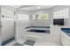 Bathroom featuring a soaking tub with glass block window and separate glass shower at 2632 Turnbull Estates Dr, New Smyrna Beach, FL 32168