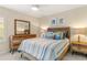 Comfortable bedroom featuring a wood-framed bed, matching dressers, and beach-themed decor at 2632 Turnbull Estates Dr, New Smyrna Beach, FL 32168