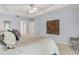 Bright bedroom featuring tray ceiling, ceiling fan, and carpeted floors at 2632 Turnbull Estates Dr, New Smyrna Beach, FL 32168