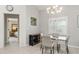 Dining area next to the living area features a glass dining table set and decorative lighting at 2632 Turnbull Estates Dr, New Smyrna Beach, FL 32168