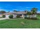 Well-maintained single-story home with a blue door, and a two car garage at 2632 Turnbull Estates Dr, New Smyrna Beach, FL 32168