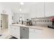 Kitchen featuring stainless steel appliances, a sink, and white cabinetry at 2632 Turnbull Estates Dr, New Smyrna Beach, FL 32168