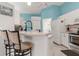 Bright kitchen with white cabinetry, bar-style counter seating, and modern faucet at 2632 Turnbull Estates Dr, New Smyrna Beach, FL 32168