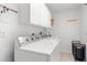 Clean laundry room featuring white cabinets, a sink, and a modern washer and dryer at 2632 Turnbull Estates Dr, New Smyrna Beach, FL 32168