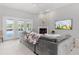 Spacious living room with fireplace, large sofa, and access to the outdoor pool at 2632 Turnbull Estates Dr, New Smyrna Beach, FL 32168