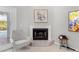 Cozy living room with fireplace, chair, and artwork at 2632 Turnbull Estates Dr, New Smyrna Beach, FL 32168