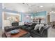 Bright living room with comfortable seating, open to a modern kitchen with bar seating and stainless steel appliances at 2632 Turnbull Estates Dr, New Smyrna Beach, FL 32168