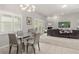 Open-concept living and dining area featuring modern lighting and a comfortable lounge space at 2632 Turnbull Estates Dr, New Smyrna Beach, FL 32168