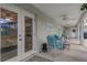 Spacious covered patio with comfortable seating, perfect for enjoying the outdoors and entertaining guests at 2632 Turnbull Estates Dr, New Smyrna Beach, FL 32168