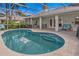 Relaxing screened-in pool with comfortable patio seating, perfect for outdoor entertaining and leisure at 2632 Turnbull Estates Dr, New Smyrna Beach, FL 32168