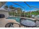 Inviting screened-in pool with lush landscaping, offering a private oasis for relaxation and recreation at 2632 Turnbull Estates Dr, New Smyrna Beach, FL 32168