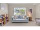 Comfortable sitting area with a bookshelf, sofa, and window views at 2632 Turnbull Estates Dr, New Smyrna Beach, FL 32168