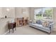 Cozy sitting area with a comfortable couch, bookshelf, and natural light at 2632 Turnbull Estates Dr, New Smyrna Beach, FL 32168