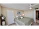 Bedroom featuring a queen-sized bed, ceiling fan, and ensuite bathroom at 2700 N Peninsula Ave # 322, New Smyrna Beach, FL 32169
