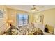 Bedroom featuring a view of the harbor, ceiling fan, and dresser at 2700 N Peninsula Ave # 322, New Smyrna Beach, FL 32169