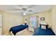Bedroom features two beds, a ceiling fan, neutral walls, and natural light at 2700 N Peninsula Ave # 322, New Smyrna Beach, FL 32169