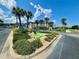 Beautiful entrance to the community, lush landscaping with a decorative fountain and palm trees at 2700 N Peninsula Ave # 322, New Smyrna Beach, FL 32169