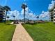 Exterior view of a community featuring a walkway, pool, palm trees, and harbor at 2700 N Peninsula Ave # 322, New Smyrna Beach, FL 32169