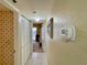 Hallway with white closet doors, access to a balcony, and a thermostat at 2700 N Peninsula Ave # 322, New Smyrna Beach, FL 32169