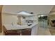 Bright, open kitchen with a breakfast bar, white cabinetry, and modern appliances at 2700 N Peninsula Ave # 322, New Smyrna Beach, FL 32169