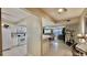 Open-concept kitchen with white cabinets, tile floors, and a breakfast bar overlooking the living area at 2700 N Peninsula Ave # 322, New Smyrna Beach, FL 32169