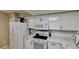 Bright kitchen features modern stainless steel appliances and white quartz countertops and white cabinetry at 2700 N Peninsula Ave # 322, New Smyrna Beach, FL 32169