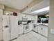 Bright kitchen featuring modern stainless steel appliances, white countertops, and white cabinetry at 2700 N Peninsula Ave # 322, New Smyrna Beach, FL 32169
