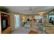 Spacious living room with seating, television, access to kitchen, and exterior view at 2700 N Peninsula Ave # 322, New Smyrna Beach, FL 32169