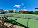 Community tennis courts with green fencing and views of the surrounding area at 2700 N Peninsula Ave # 322, New Smyrna Beach, FL 32169