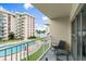 Balcony with seating overlooks a swimming pool, and grassy area at 2711 N Halifax Ave # 372, Daytona Beach, FL 32118