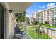 Relaxing balcony with a chair overlooks manicured lawns and lush landscaping with a building view at 2711 N Halifax Ave # 372, Daytona Beach, FL 32118