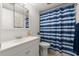 Neat bathroom with a sink and cabinet plus a shower with a striped curtain at 2711 N Halifax Ave # 372, Daytona Beach, FL 32118