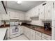Efficient kitchen with modern appliances and white cabinets at 2711 N Halifax Ave # 372, Daytona Beach, FL 32118