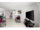 Open-concept living room with tile floors, comfortable seating, and a large TV at 2711 N Halifax Ave # 372, Daytona Beach, FL 32118