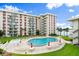 Inviting outdoor pool area with condo buildings and manicured lawn creating relaxation at 2711 N Halifax Ave # 372, Daytona Beach, FL 32118