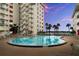 Community pool with lounge chairs and palm trees offers a relaxing outdoor space at 2711 N Halifax Ave # 372, Daytona Beach, FL 32118