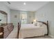 Cozy bedroom with a wood frame bed, dresser, decor, and a window that brings in plenty of natural light at 2733 Neverland Dr, New Smyrna Beach, FL 32168