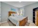 Bright bedroom featuring a wooden bed frame, matching decor, and a window that brings in plenty of natural light at 2733 Neverland Dr, New Smyrna Beach, FL 32168