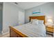 Bright bedroom featuring a wooden bed frame, matching decor, and a window that brings in plenty of natural light at 2733 Neverland Dr, New Smyrna Beach, FL 32168