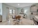 Dining area boasts a wood table, sliding glass door to the patio, and a decorative hutch at 2733 Neverland Dr, New Smyrna Beach, FL 32168