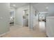Hallway view featuring the laundry room, bedroom, living room, and neutral-colored tiling at 2733 Neverland Dr, New Smyrna Beach, FL 32168