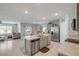 Open-concept kitchen with stainless steel appliances, a center island, and views into the living area at 2733 Neverland Dr, New Smyrna Beach, FL 32168