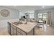 Open concept kitchen with island, stainless steel dishwasher and view of the living room and dining area at 2733 Neverland Dr, New Smyrna Beach, FL 32168