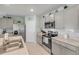 Bright kitchen with stainless steel appliances, light gray cabinets, and an eat-in island at 2733 Neverland Dr, New Smyrna Beach, FL 32168