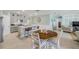 Bright kitchen and dining area featuring stainless steel appliances, a breakfast bar, and a dining table at 2733 Neverland Dr, New Smyrna Beach, FL 32168