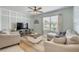 Comfortable living room featuring a large window, neutral paint, stylish furniture, and a ceiling fan at 2733 Neverland Dr, New Smyrna Beach, FL 32168