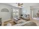 A well-lit living room boasts neutral paint, a ceiling fan, and a comfortable sectional sofa at 2733 Neverland Dr, New Smyrna Beach, FL 32168