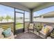 Screened lanai with comfortable seating, offering a relaxing outdoor space with a view of the backyard at 2733 Neverland Dr, New Smyrna Beach, FL 32168